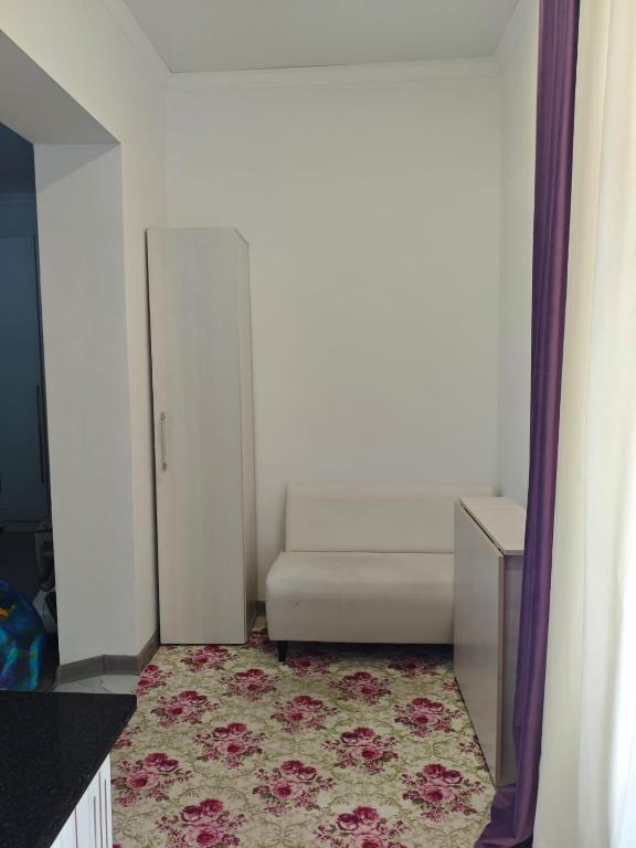 a white couch in a room with a rug at Dos in Kapchagay
