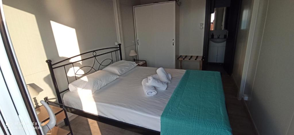 a bedroom with a bed with towels on it at Villa Nikitas Beach in Agios Nikitas