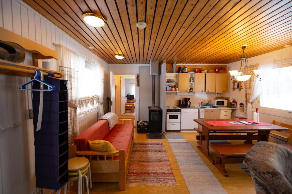 a living room with a couch and a table at Heidin Mummola Farm in Turtola