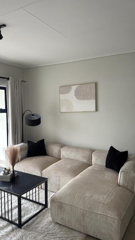 a living room with two couches and a coffee table at Elara in Sandton