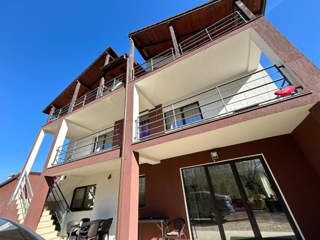 ein Mehrfamilienhaus mit Balkon und Terrasse in der Unterkunft Vila Ema Râşnov in Râșnov