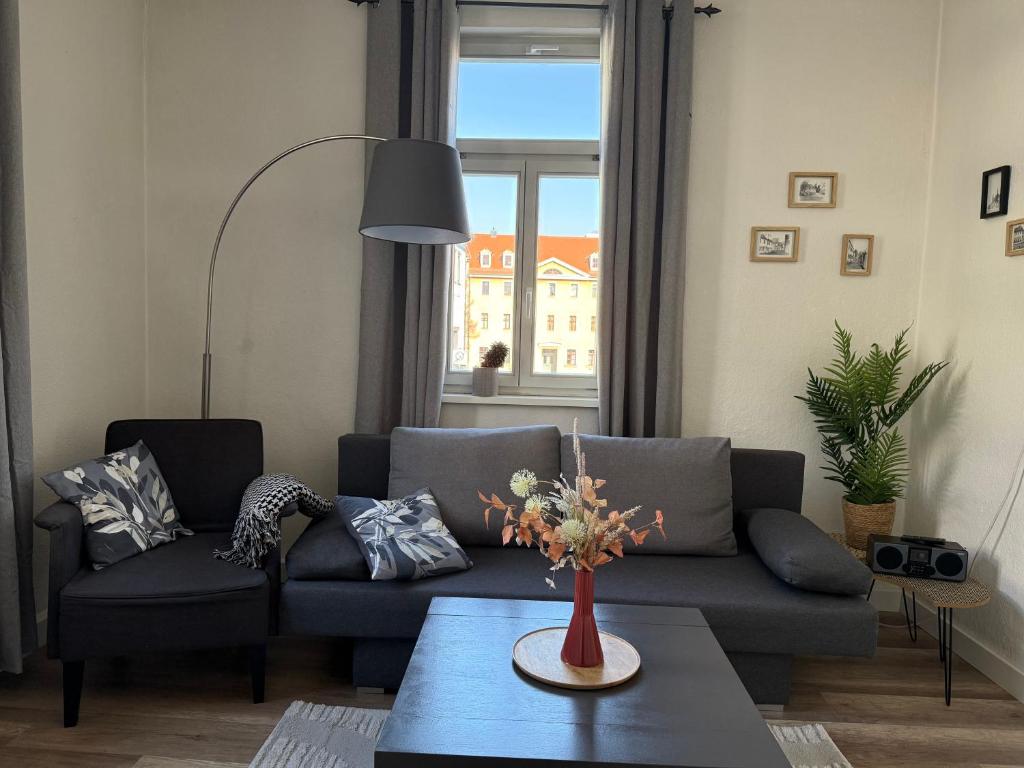 a living room with a couch and a table at Ferienapartment Weimar Altstadt 1 in Weimar