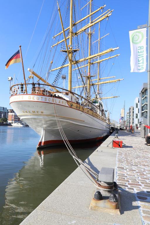 a large boat is docked in the water at Schulschiff Deutschland Bremerhaven in Bremerhaven