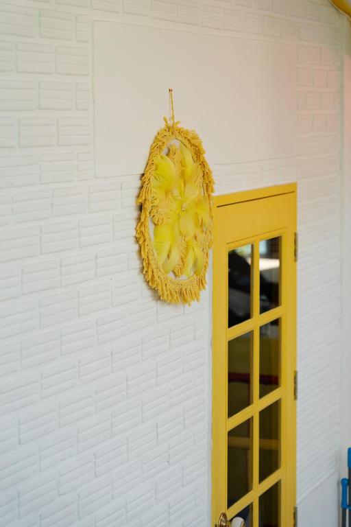 a wreath hanging on a wall next to a door at Beachfront Villa with Sunset in Ban Bang Po