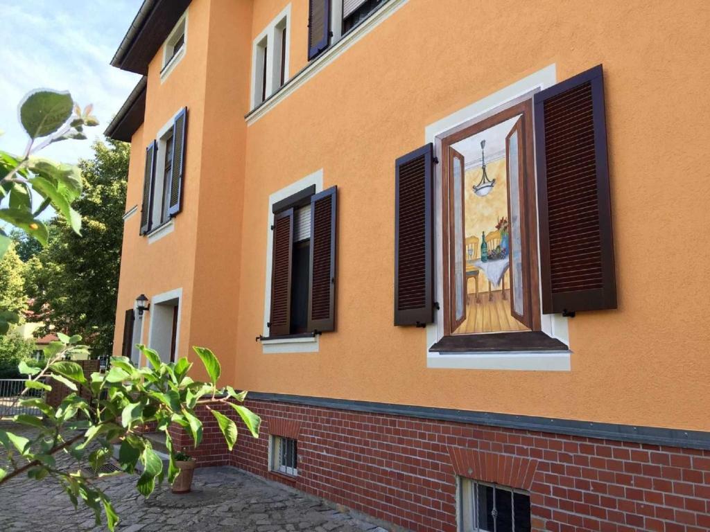 a building with a window with a painting on it at Pension Max in Senftenberg