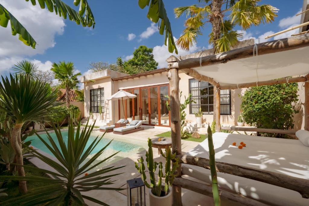 an exterior view of a house with a swimming pool at Villa Mahuwa in Canggu