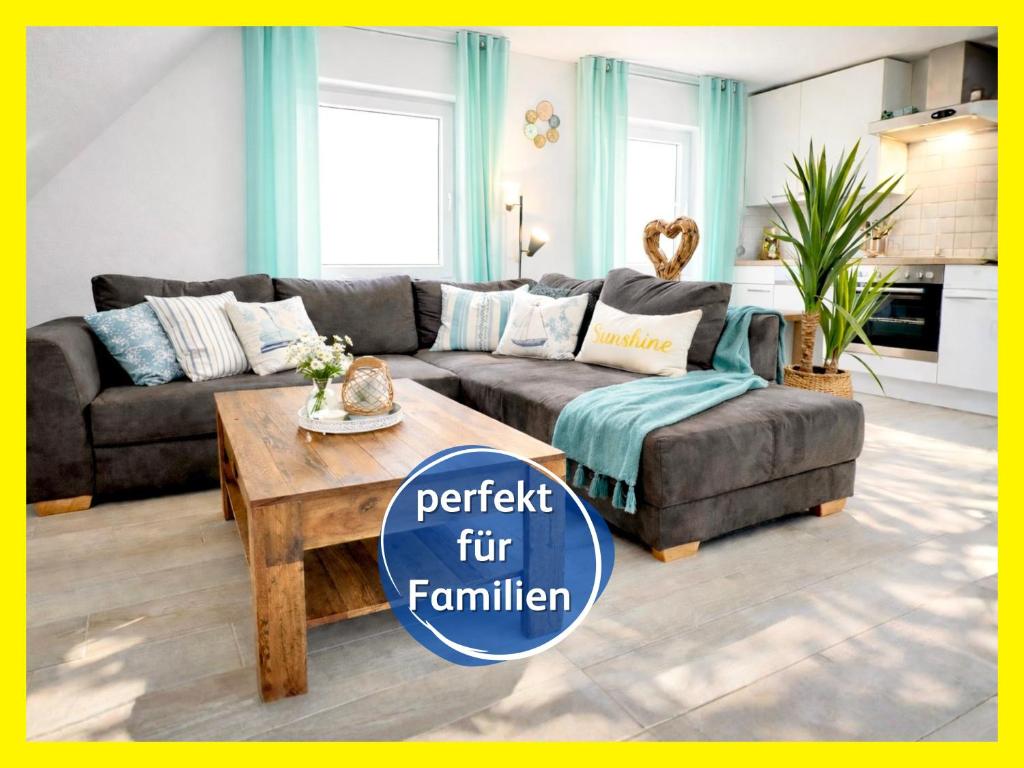 a living room with a couch and a coffee table at strandnahe Familien-Oase mit Kinderbuggy in Bensersiel
