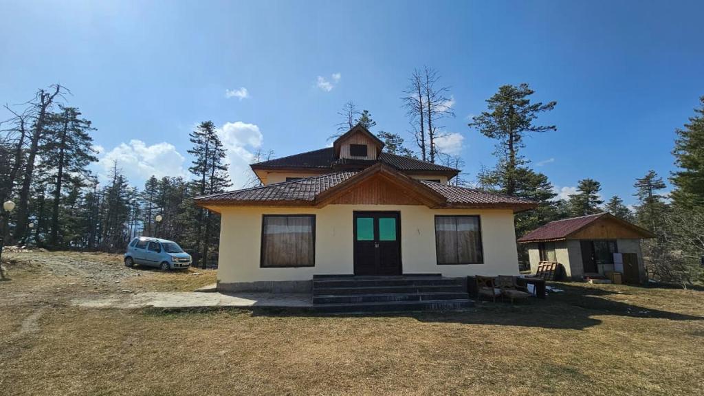 a small house in the middle of a field at Grand Mumtaz Tangmarg in Tangmarg