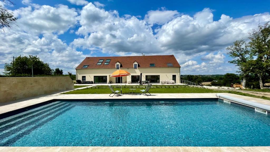 a house with a swimming pool in front of a house at L'Echo du Bonheur in Vaumas