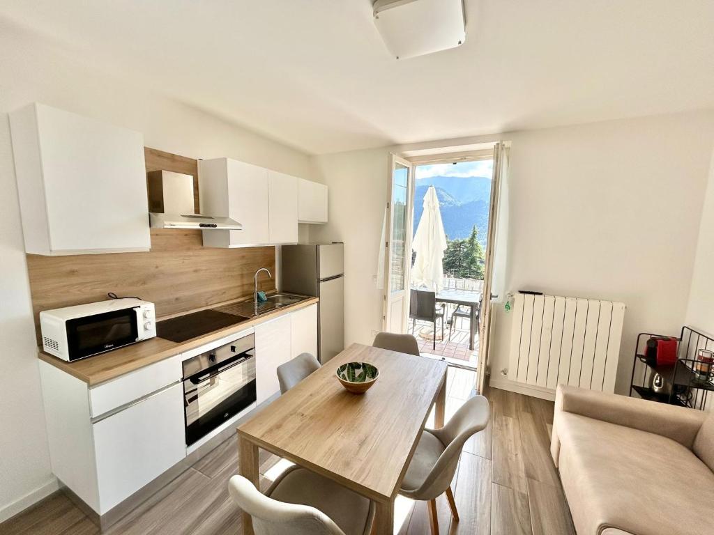 a kitchen and dining room with a table in a room at Relax Home in Clusone