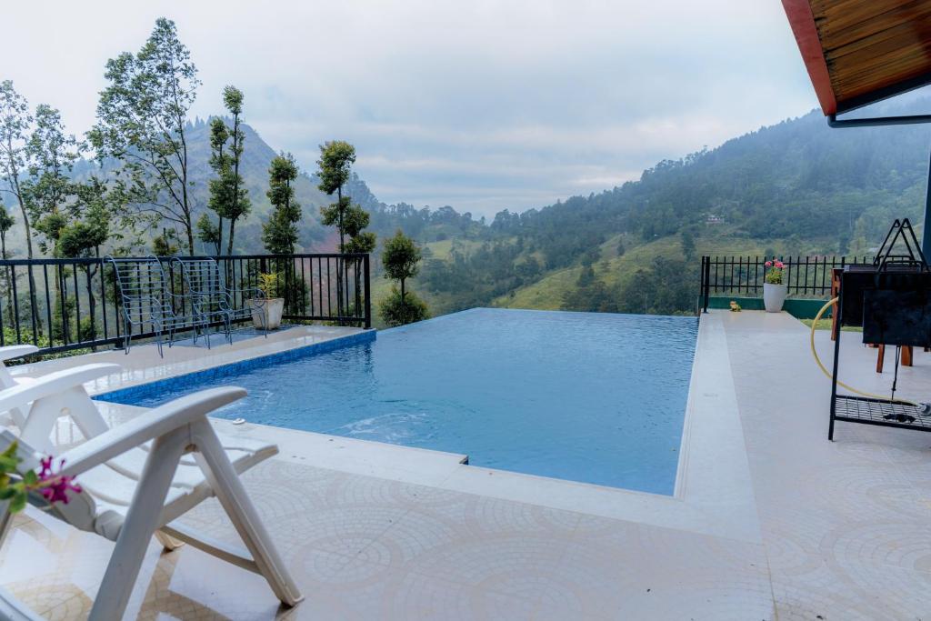 a swimming pool with a view of a mountain at Glenbourne Bungalow in Galaha Town