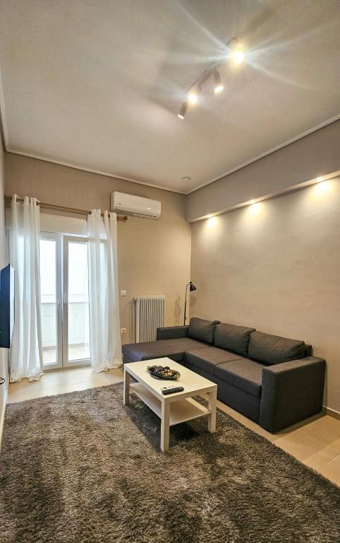 a living room with a couch and a table at Efrosini's by the sea apartment in Chalkida