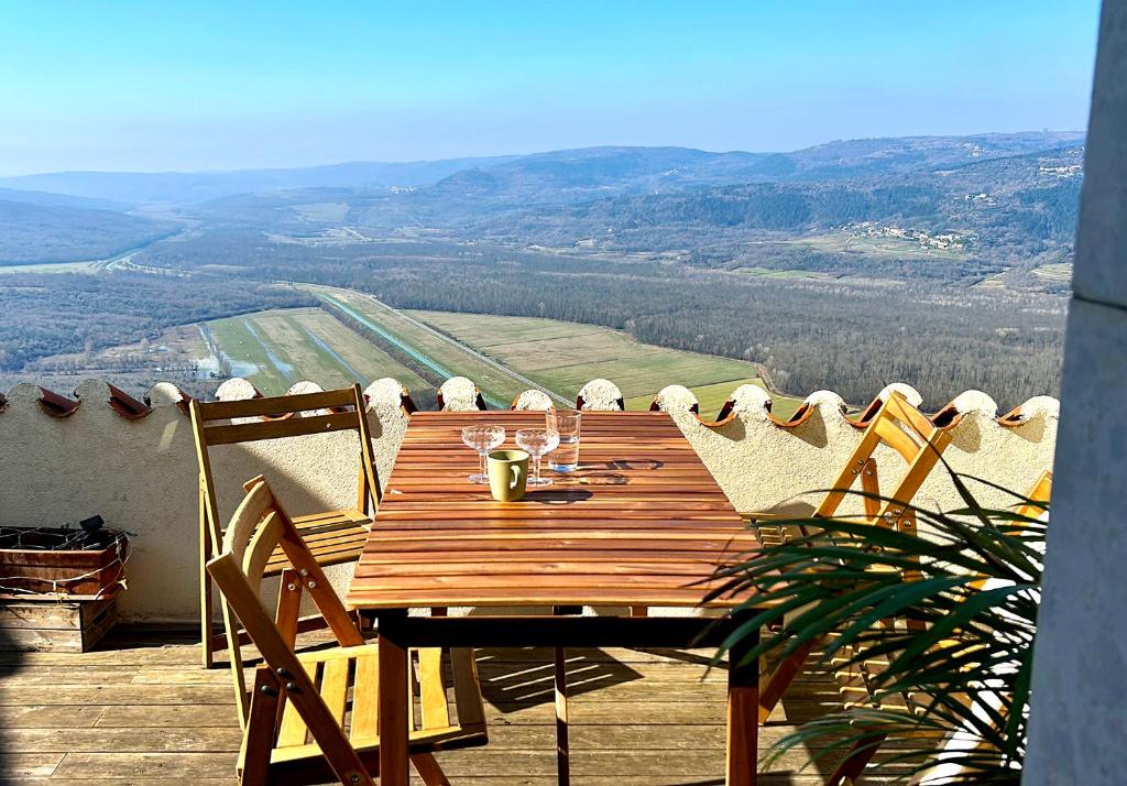 a wooden table on a balcony with a view at The View in Motovun