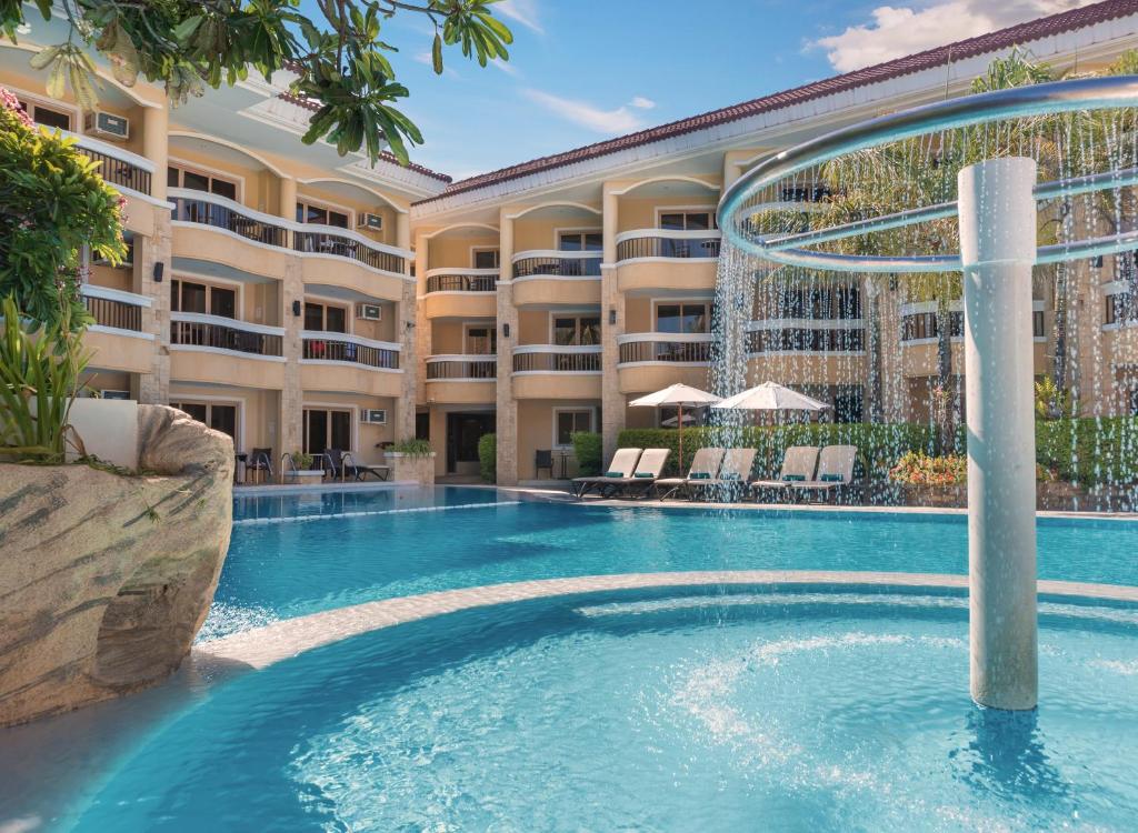 a pool at a resort with a fountain at Henann Regency Resort and Spa in Boracay