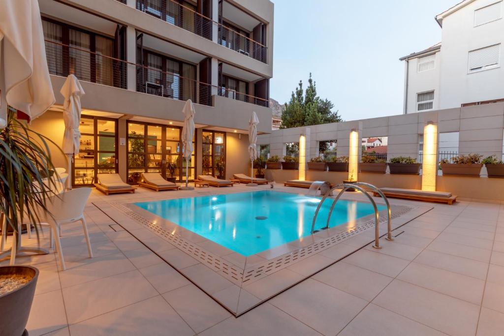 a swimming pool in the middle of a building at Hotel Nestos in Omiš