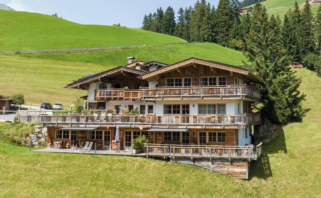 a large house on a hill with green grass at Ferienhof Ausserbrente in Tux