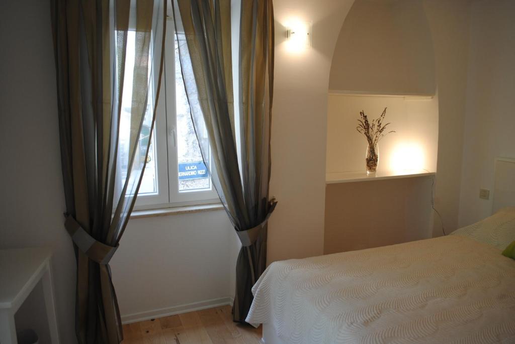 Postel nebo postele na pokoji v ubytování Rooms Piazzetta