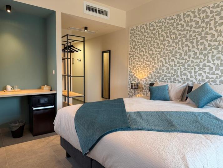 a bedroom with a large bed and a counter at Le Fourquet Blaugies - Hôtel & restaurant in Dour