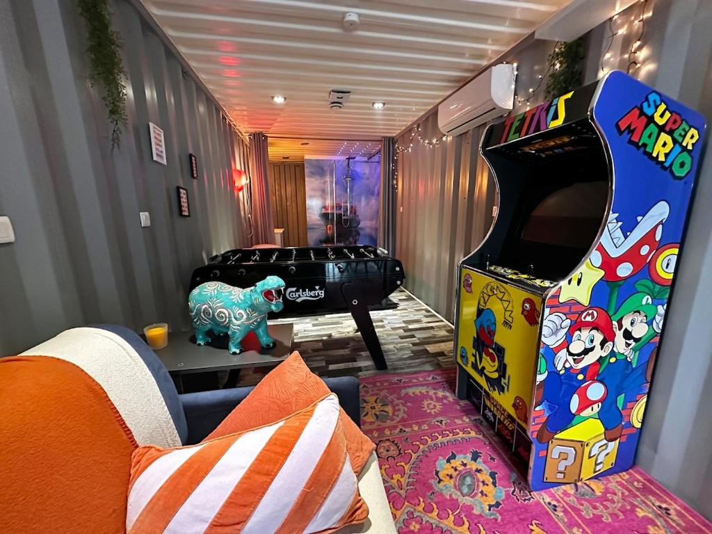 a living room with a video game arcade machine at Séjour insolite dans un Container aménagé à Berck avec Borne d'arcade et Babyfoot in Berck-sur-Mer