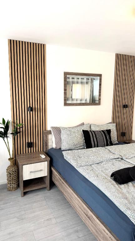 a bedroom with a blue bed and a table at Chloraka Bay Studio in Khlorakas