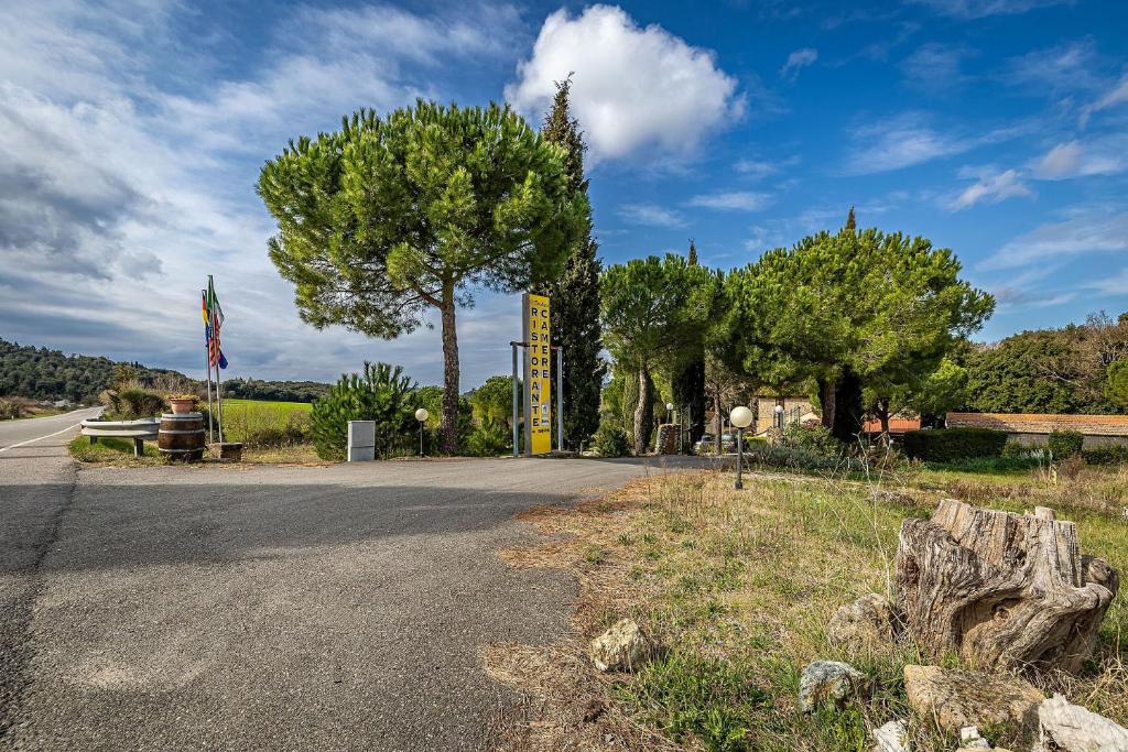 an empty road with trees on the side of the road at Locanda il Boschetto in Volterra
