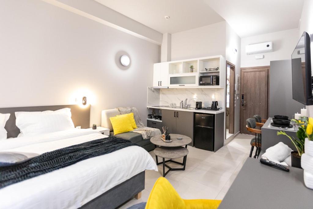 a hotel room with a bed and a living room at Breeze Apartments Megara - Linea in Megara