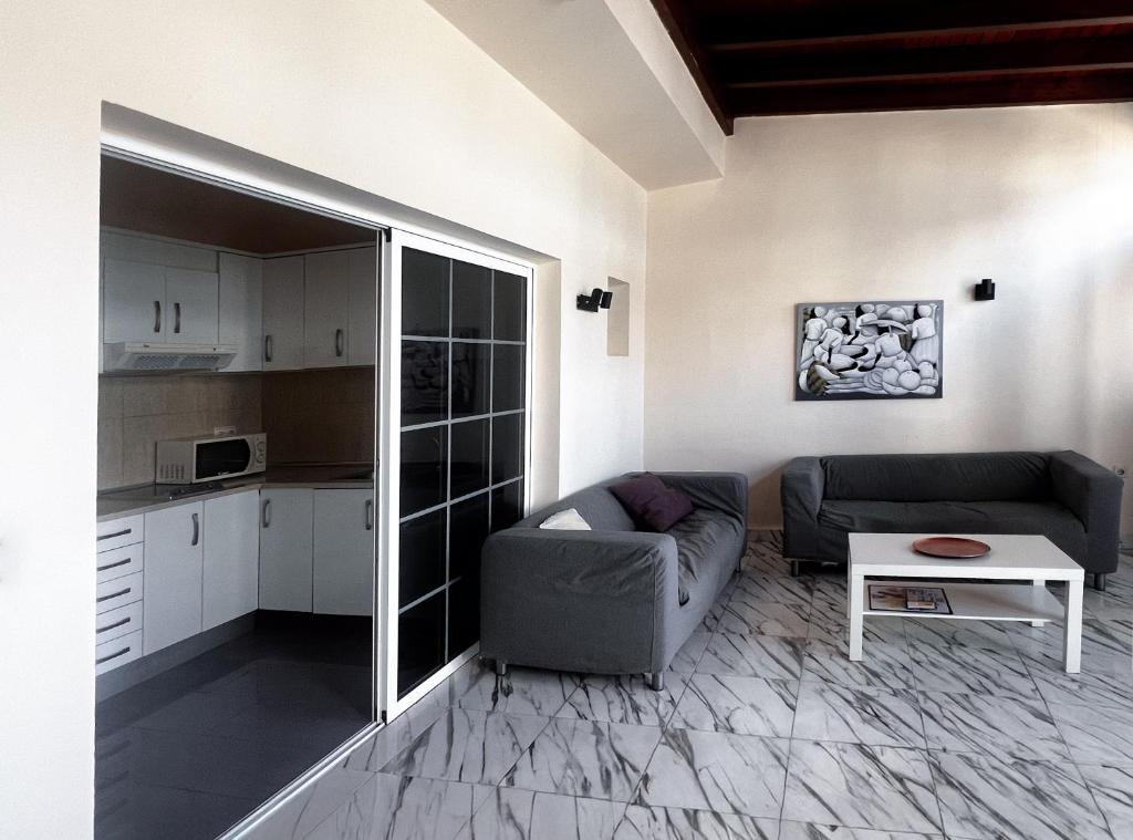 a living room with a couch and a table at Paradise in El Cotillo in El Cotillo