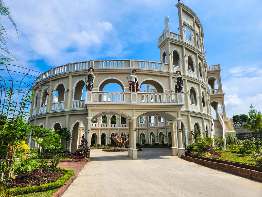 a large building with a balcony on top of it at Chevilly Resort & Camp in Bogor