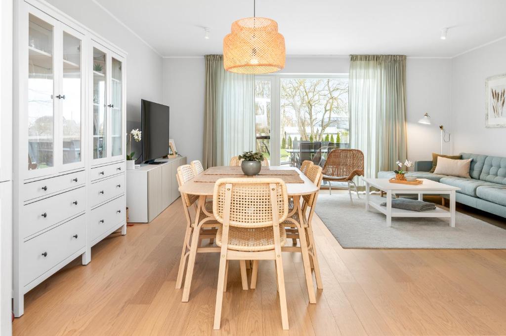 a kitchen and living room with a table and chairs at Metsa terraced house in Haapsalu