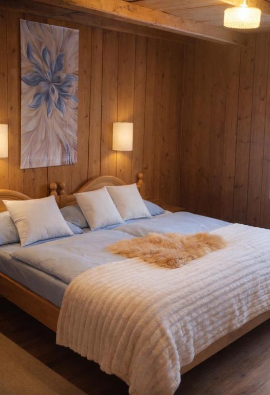 a bedroom with a large bed with wooden walls at Alpwirtschaft Heirihütte in Rigi Klösterli