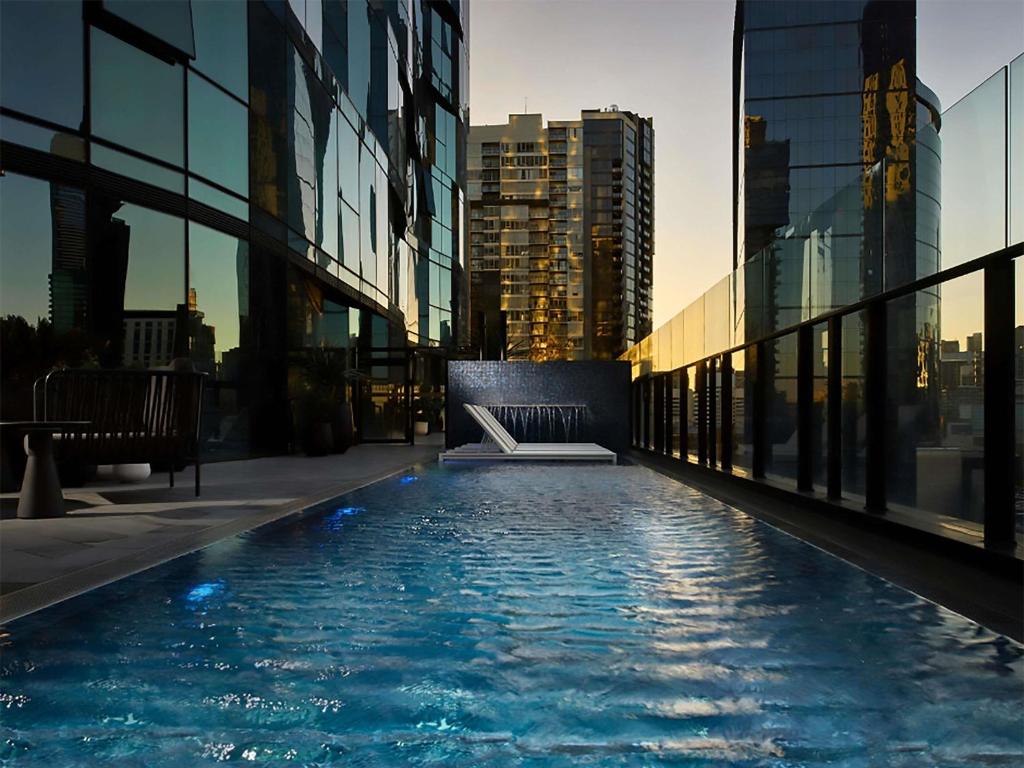 a swimming pool on the side of a building at Shadow Play by Peppers in Melbourne