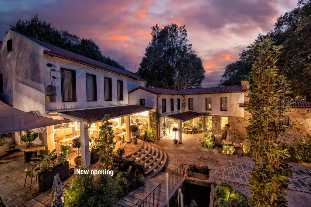 an aerial view of a house with a patio at night at Hotel Sarela Natura in Santiago de Compostela