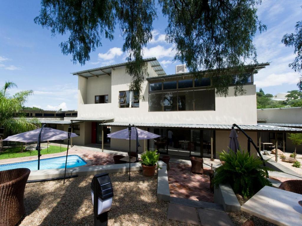 an exterior view of a house with a swimming pool at Monte Bello Guesthouse in Windhoek
