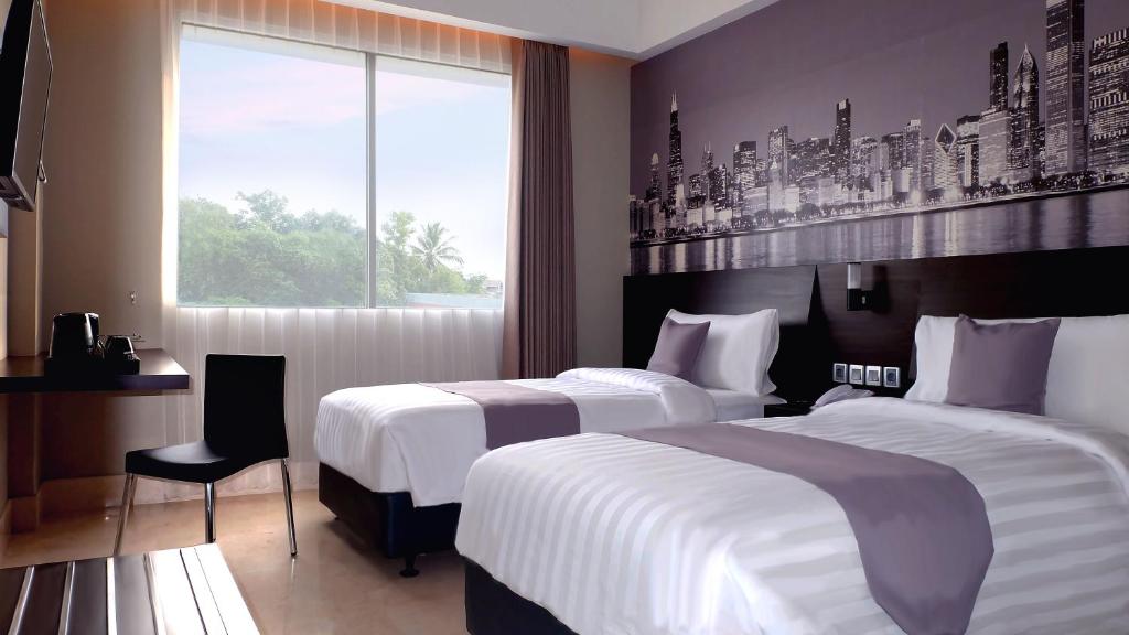 Postel nebo postele na pokoji v ubytování Hotel Neo+ Balikpapan by ASTON