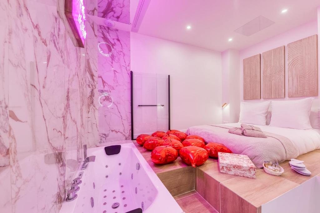 a bedroom with a large bed and a tub at Jacuzzi Romantique, Cosy, Home Cinéma, Paris 10min in Clichy