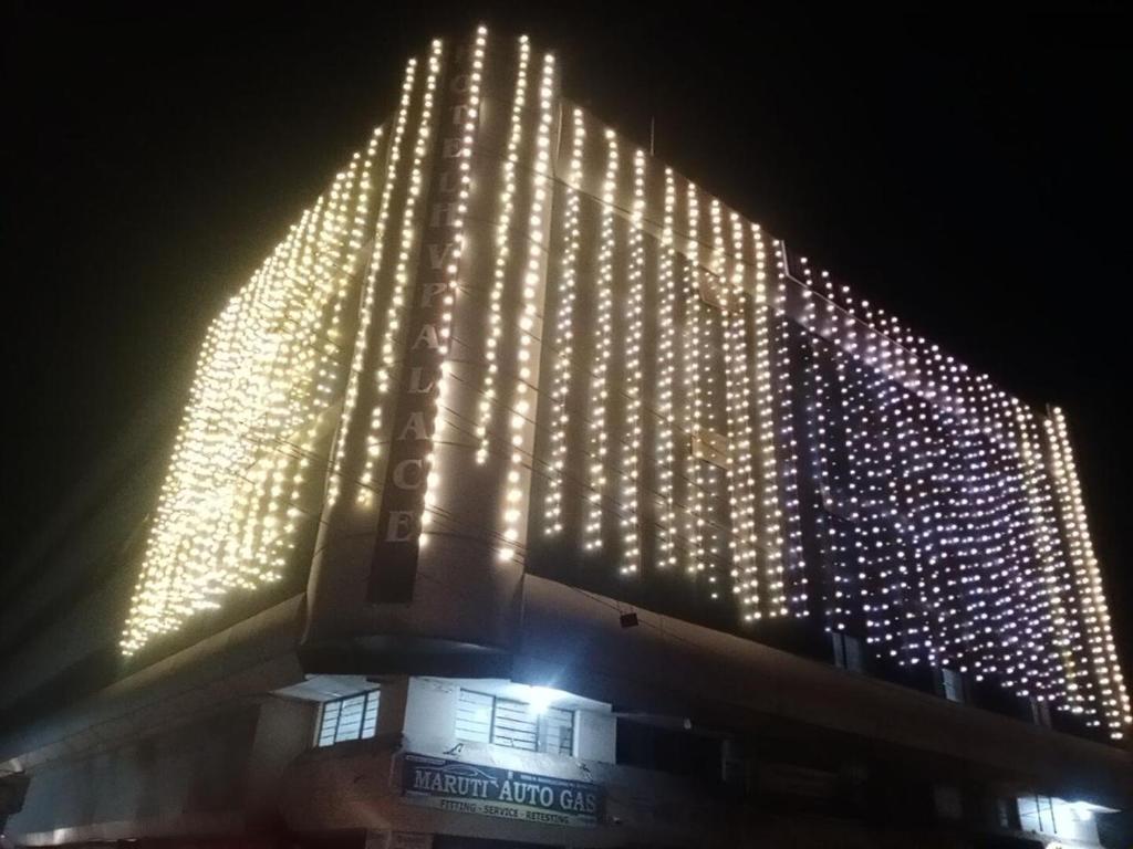 a large building with lights on it at night at Hotel HV Palace in Bhuj