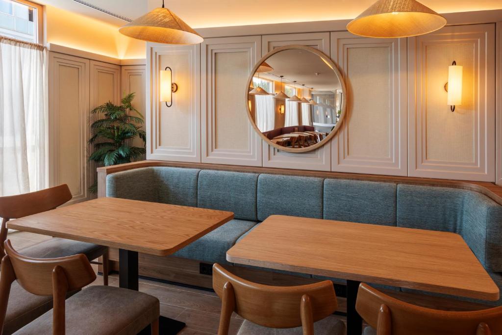 a restaurant with two tables and a mirror at B&B HOTEL Madrid Vallecas Ensanche in Madrid