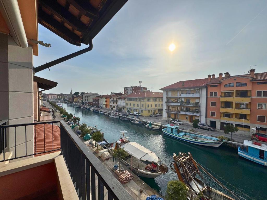 a view of a river with boats in a city at Stella Marina in Grado