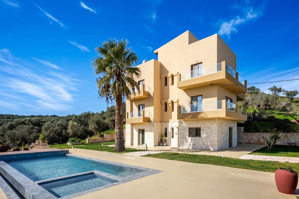 a house with a swimming pool in front of it at Chrisselen Stalos in Chania
