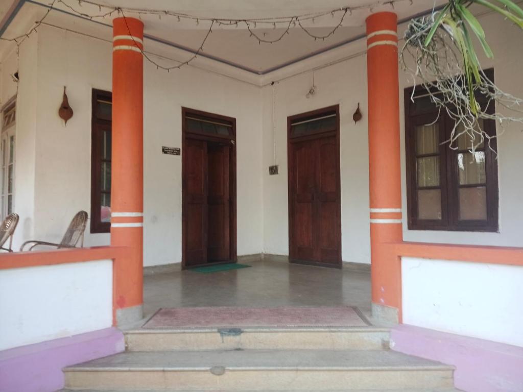 a house with two columns and two doors at First Alleppey homestay in Alleppey
