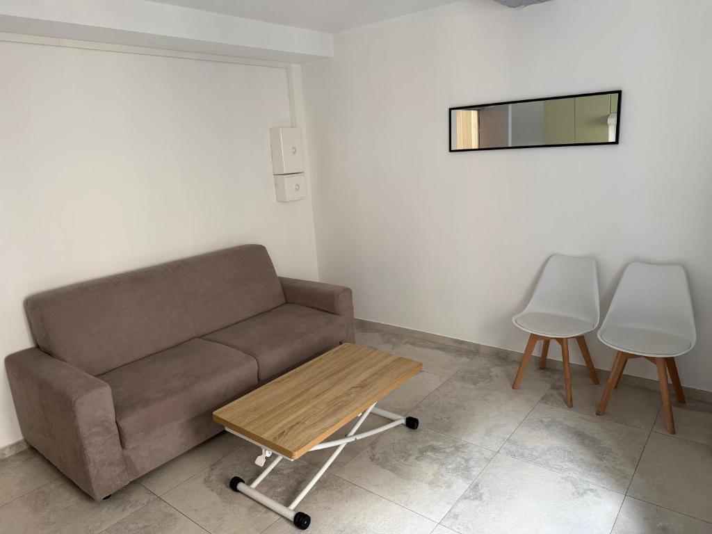a living room with a couch and a table at Appartement La Colle sur Loup in La Colle-sur-Loup