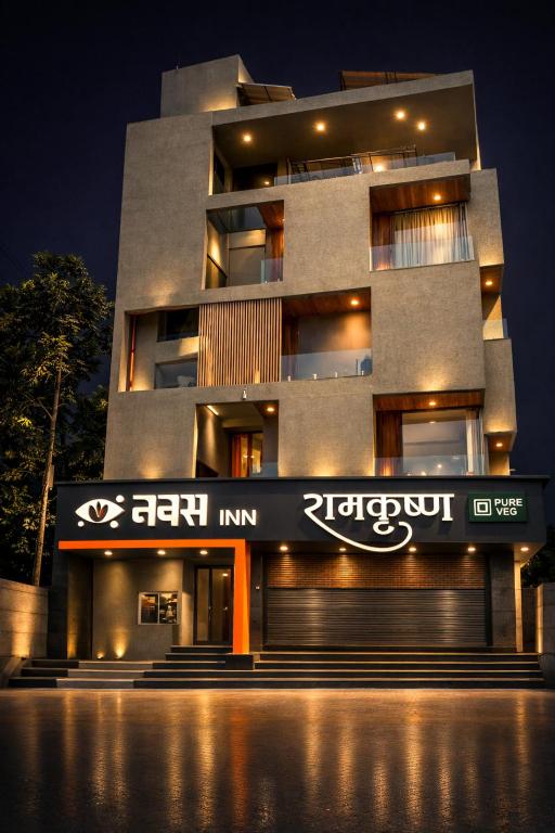 a building with a sign on the side of it at Hotel Navas Inn- Pure Veg, Kolhapur in Kolhapur