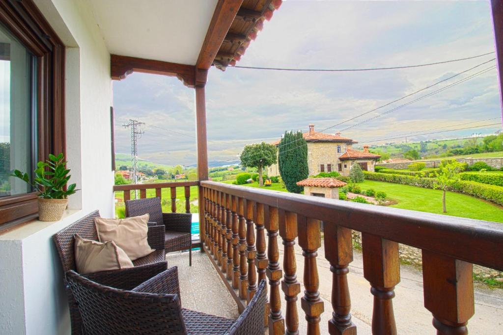 a balcony with chairs and a view of a house at La balcon de Sanfer in Santillana del Mar