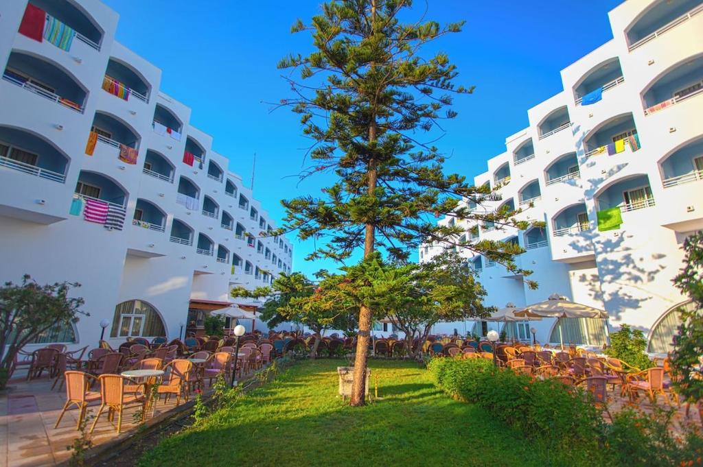 a tree in the courtyard of a building at Continental Palace in Psalidi