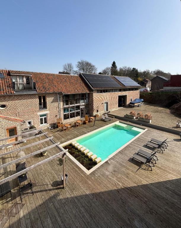 a swimming pool in front of a house at EBURON estate Boutique B&B in Diets-Heur