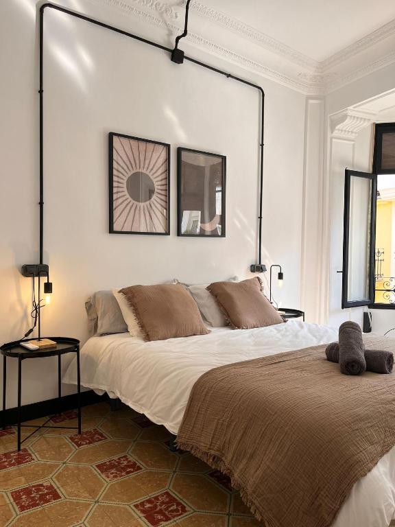 a bedroom with a large bed and a mirror on the wall at Terrazas de la Catedral II in Castellón de la Plana