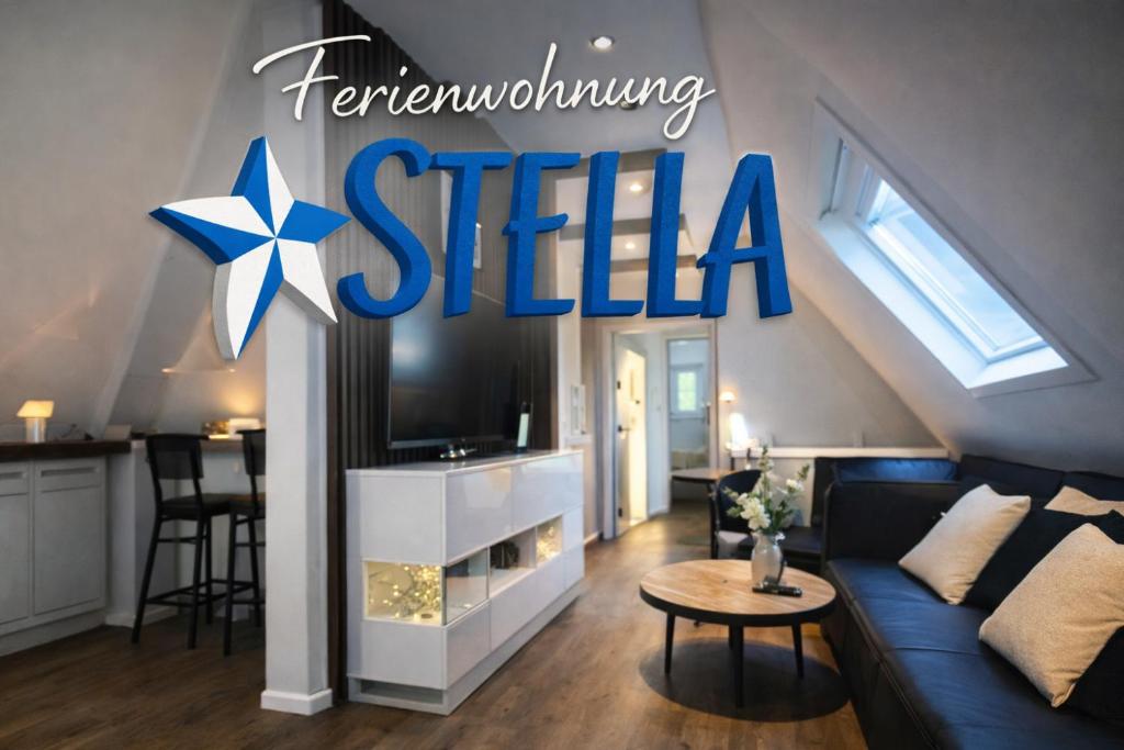 a living room with a blue couch and a star sign at Eine sehr gemütliche Dachgeschoß Ferienwohnung in Ihlow