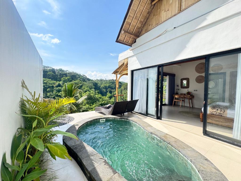 a swimming pool in a villa with a patio at Jungle Valley Villas in Susut