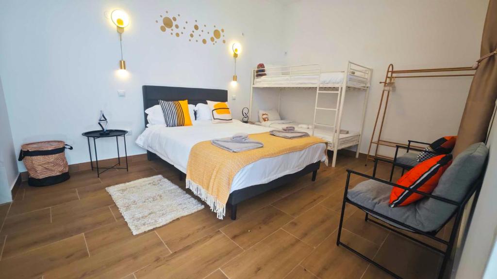 a bedroom with a bed and a bunk bed at Cascais Garden House in Cascais