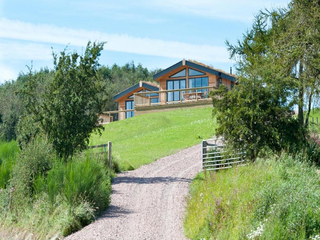 a house on a hill with a dirt road at 3 Bed in St. Andrews oc-88545 in Balmullo